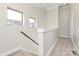 Well-lit staircase with neutral carpeting and white trim creates a clean, modern look at 1037 Pierre Dr, Charlotte, NC 28205