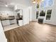 Bright living room with fireplace, wood floors, and an open layout to the kitchen at 1269 E Woodlawn Rd, Charlotte, NC 28209