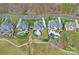 Stunning aerial view of estate homes with pools, manicured lawns, and lush surroundings at 13500 Robert Walker Dr, Davidson, NC 28036