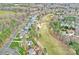 Extensive aerial shot showcasing the neighborhood, golf course, mature trees, and well-kept lawns at 13500 Robert Walker Dr, Davidson, NC 28036