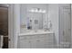 Well-lit bathroom featuring a vanity with great storage and a shower with glass doors at 13500 Robert Walker Dr, Davidson, NC 28036