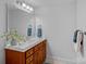 Bathroom featuring a modern vanity and decorative mirror, complimented by modern fixtures at 13500 Robert Walker Dr, Davidson, NC 28036