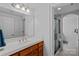 Bathroom featuring a modern vanity with double sinks and a glass-enclosed walk-in shower at 13500 Robert Walker Dr, Davidson, NC 28036