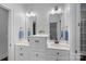 Bright bathroom with dual sinks, white cabinetry, and a modern, minimalist design at 13500 Robert Walker Dr, Davidson, NC 28036
