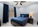 Cozy bedroom featuring a window with blue curtains and blue bedding with accent pillow at 13500 Robert Walker Dr, Davidson, NC 28036
