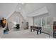 Spacious bonus room with a foosball table, desk, and ample natural light at 13500 Robert Walker Dr, Davidson, NC 28036