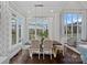 Sunlit dining room with modern chandelier, views of outdoors, and seating for six at 13500 Robert Walker Dr, Davidson, NC 28036