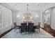 Bright dining room featuring a large table, stylish lighting, and neutral decor for elegant dining at 13500 Robert Walker Dr, Davidson, NC 28036