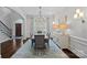 Formal dining room with elegant chandelier, hardwood floors, and ample natural light at 13500 Robert Walker Dr, Davidson, NC 28036
