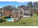 Beautiful exterior view of home, showcasing the expansive backyard, private pool, and deck area at 13500 Robert Walker Dr, Davidson, NC 28036