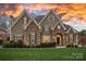 Charming home featuring stone accents, a well-manicured lawn, and a welcoming front entrance at 13500 Robert Walker Dr, Davidson, NC 28036