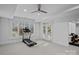 Bright exercise room with a treadmill, windows overlooking the yard, and a ceiling fan for optimal ventilation at 13500 Robert Walker Dr, Davidson, NC 28036