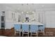 Stunning kitchen features a large island with marble countertops, pendant lighting, and custom blue-patterned seating at 13500 Robert Walker Dr, Davidson, NC 28036