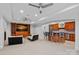Modern living room with a sleek bar, built-in entertainment center and comfortable seating at 13500 Robert Walker Dr, Davidson, NC 28036