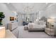 Expansive main bedroom suite boasting tray ceilings, bay windows, and a luxurious seating area at 13500 Robert Walker Dr, Davidson, NC 28036