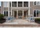 Inviting covered patio features stone pillars and modern furniture, perfect for outdoor relaxation and entertaining at 13500 Robert Walker Dr, Davidson, NC 28036