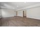 Unfinished basement area featuring neutral walls, wood flooring, and access to additional rooms and storage at 136 Glenn Dr, Mooresville, NC 28115