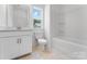 Full bathroom with a tub-shower combination, white toilet, and bright vanity with window at 136 Glenn Dr, Mooresville, NC 28115