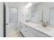 Bathroom featuring double sink vanity with granite countertops and white cabinets, and framed mirrors at 136 Glenn Dr, Mooresville, NC 28115