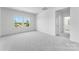 Bright bedroom with two windows offering natural light and view of the outdoors, and light gray carpet at 136 Glenn Dr, Mooresville, NC 28115