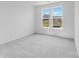 Bedroom with views to the outdoors, light gray carpet, and neutral walls at 136 Glenn Dr, Mooresville, NC 28115