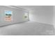 A bright bedroom features large windows and tray ceiling at 136 Glenn Dr, Mooresville, NC 28115