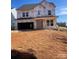 New construction home featuring an attached garage and covered front porch awaiting final exterior finishes at 136 Glenn Dr, Mooresville, NC 28115