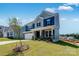 Charming two-story home featuring stone accents, a two-car garage, and manicured front lawn at 136 Glenn Dr, Mooresville, NC 28115