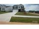 Two-story home with a manicured lawn, a concrete driveway and a two-car garage at 136 Glenn Dr, Mooresville, NC 28115