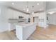 Bright kitchen featuring white cabinets, quartz countertops, stainless steel appliances, and pendant lights at 136 Glenn Dr, Mooresville, NC 28115