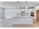 Bright kitchen with white cabinets, quartz countertops, stainless steel appliances, and modern lighting at 136 Glenn Dr, Mooresville, NC 28115