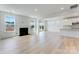 Open-concept living area with a fireplace, light wood flooring, and sliding glass doors at 136 Glenn Dr, Mooresville, NC 28115