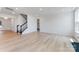 Spacious living room with light hardwood floors, staircase, and ample natural light at 136 Glenn Dr, Mooresville, NC 28115