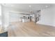 Open-concept layout with a kitchen, staircase, and large living area with light wood flooring at 136 Glenn Dr, Mooresville, NC 28115