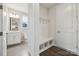 Convenient mudroom features built-in bench with storage and a half bathroom at 136 Glenn Dr, Mooresville, NC 28115