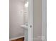 Half-bath includes a pedestal sink and modern fixtures at 13684 Meade Glen Ct, Charlotte, NC 28273