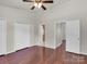 Large bedroom features a ceiling fan, hardwood flooring, and neutral walls at 13684 Meade Glen Ct, Charlotte, NC 28273