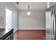 Bright dining area features hardwood floors, modern lighting, and sliding glass doors to let in natural light at 13684 Meade Glen Ct, Charlotte, NC 28273