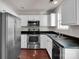 Kitchen with white cabinets, stainless steel appliances, and hardwood floors at 13684 Meade Glen Ct, Charlotte, NC 28273