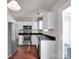 Kitchen with white cabinets, stainless steel appliances, and hardwood floors at 13684 Meade Glen Ct, Charlotte, NC 28273