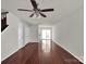 Spacious living room featuring hardwood floors and a ceiling fan at 13684 Meade Glen Ct, Charlotte, NC 28273