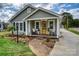 Charming home featuring a welcoming front porch with decorative plants and brick walkway at 1532 South Point Rd, Belmont, NC 28012