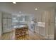 Modern kitchen with white cabinets, stainless steel appliances, and a central island with bar stools at 1532 South Point Rd, Belmont, NC 28012