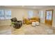 Bright living room featuring light hardwood floors, large windows, and comfortable seating at 1532 South Point Rd, Belmont, NC 28012