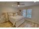 Bright main bedroom features hardwood floors, plantation shutters, and a ceiling fan at 1532 South Point Rd, Belmont, NC 28012