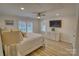 Spacious main bedroom features a ceiling fan, television, and plantation shutters at 1532 South Point Rd, Belmont, NC 28012