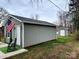 View of a gray shed with an American flag displayed outside, and a second shed located in the background at 1532 South Point Rd, Belmont, NC 28012