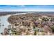 Stunning aerial view of a lake community featuring waterfront homes with private docks and serene water views at 156 Hazelton Loop, Mooresville, NC 28117
