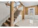 Carpeted stairs leading to a basement with wood paneling and a door to the outside at 156 Hazelton Loop, Mooresville, NC 28117