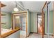 Bathroom featuring a shower, toilet, and wooden vanity with vintage light fixture at 156 Hazelton Loop, Mooresville, NC 28117